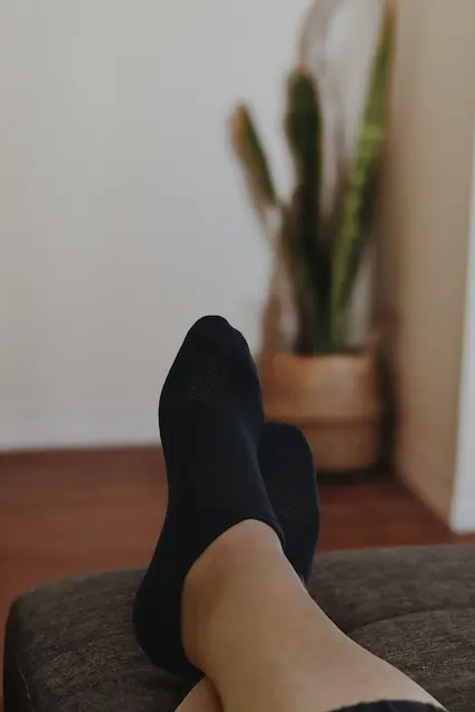 Mobile massage therapist providing relaxing foot massage in client's home in Preston